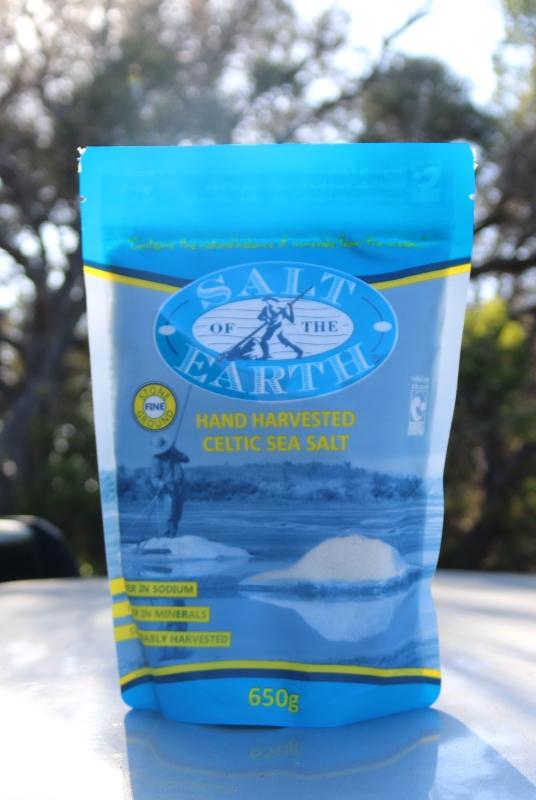 "Front view of a 650g blue resealable pouch labeled 'Salt of the Earth – Hand Harvested Celtic Sea Salt.' The packaging features an illustration of traditional salt harvesting, with claims such as 'Stone Ground Fine,' 'Lower in Sodium,' 'Higher in Minerals,' and 'Sustainably Harvested.'